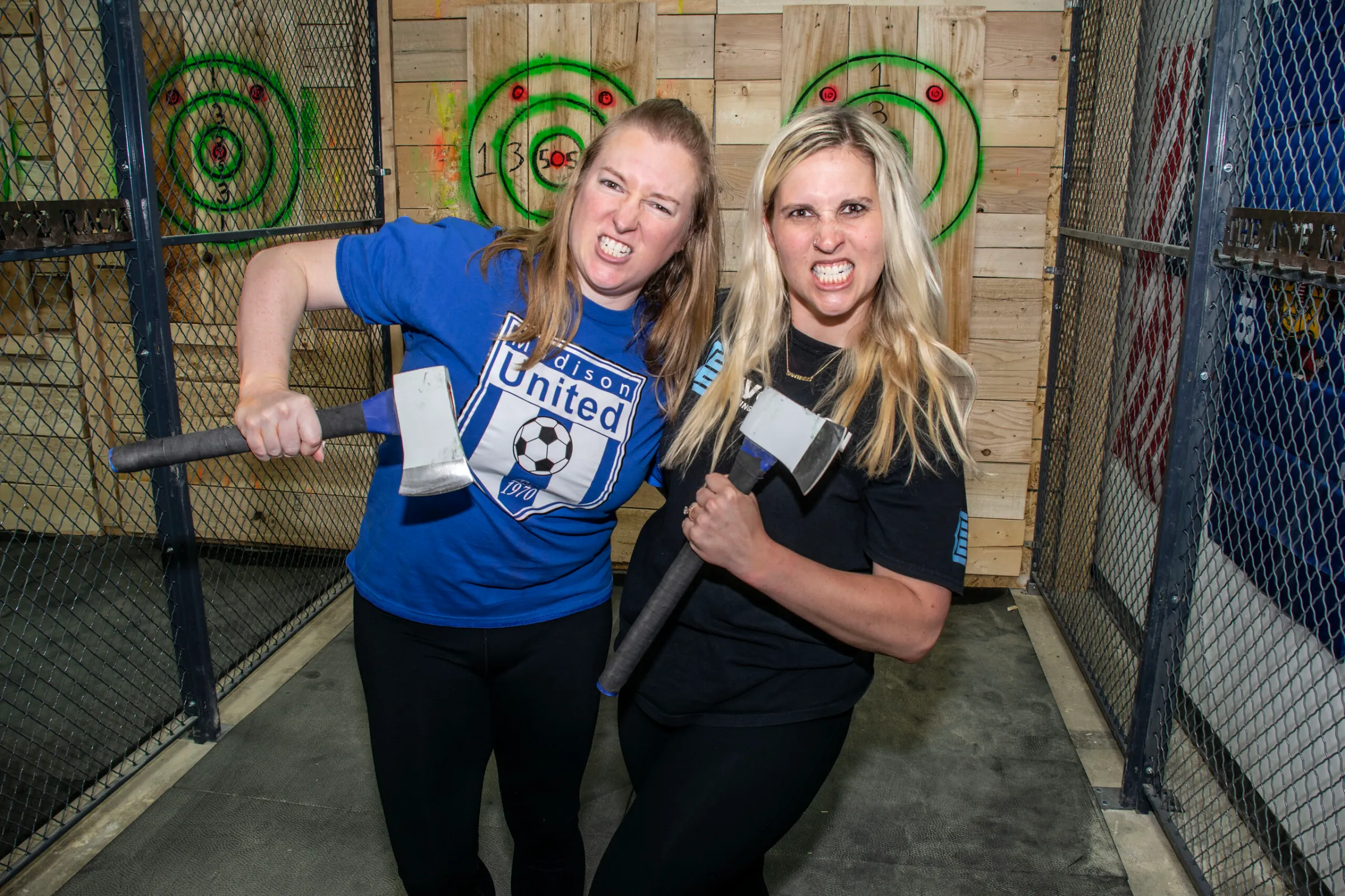 a little girl standing in front of a fence