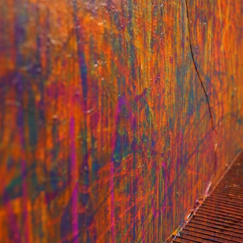 Vibrant abstract wall art with colorful paint splatters and streaks.