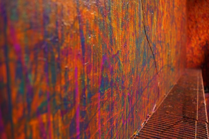 Vibrant abstract wall art with colorful paint splatters and streaks.